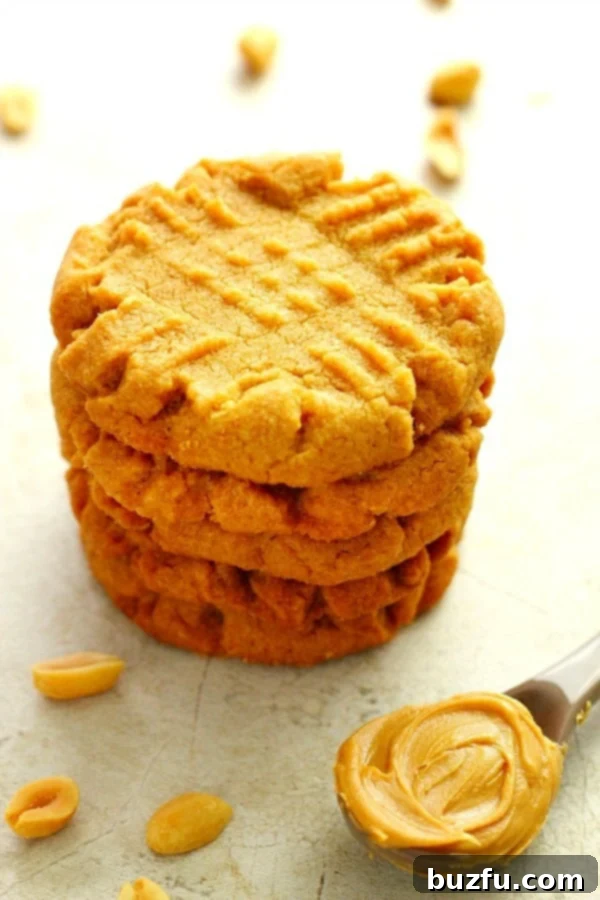 Delicious Flourless Peanut Butter Cookies Stack Side shot of perfectly baked flourless peanut butter cookies in a stack, golden brown and inviting.