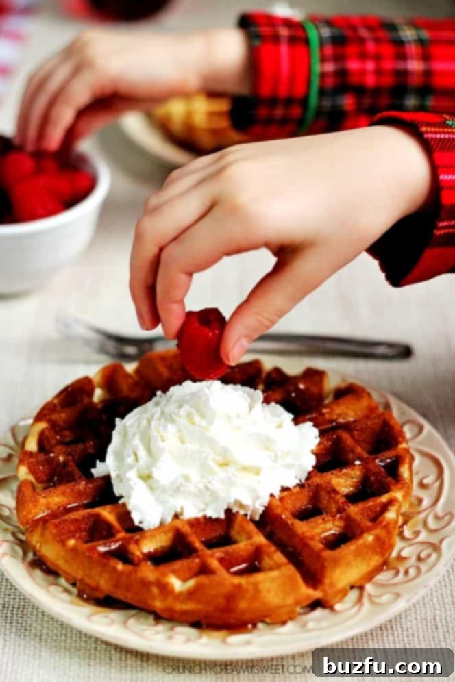Sunday Morning Waffle Perfection 3 Close-up of the Best Sunday Waffles topped with fresh berries, powdered sugar and maple syrup