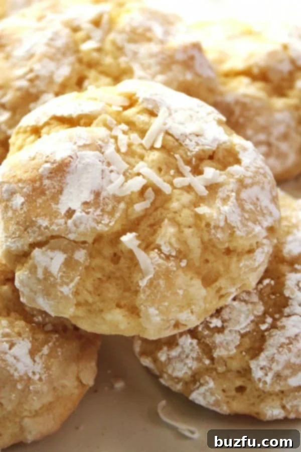 Plate of perfectly baked Coconut Crinkle Cookies, showing their signature cracked, sugary tops.