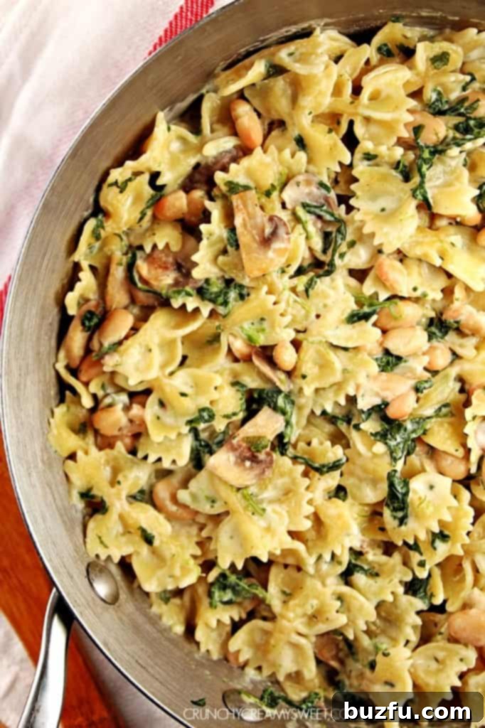 One-Pot Wonder Pasta: creamy mushroom, spinach, and bean pasta cooking in a single pot