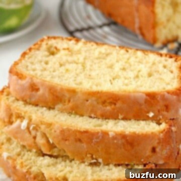 Glazed Lemon Coconut Loaf cake sliced on plate.