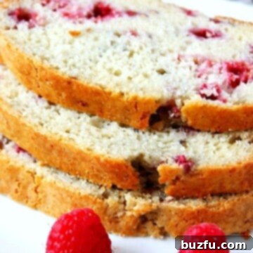 Slices of Lemon Raspberry Quick Bread arranged on a white plate, ready to be served.
