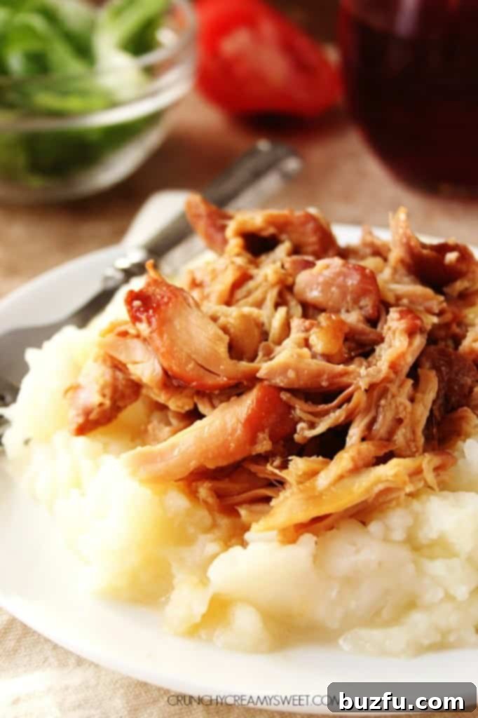 Close-up of Sweet Garlic Chicken cooking in a slow cooker, showcasing the rich, glazed sauce and tender chicken thighs.