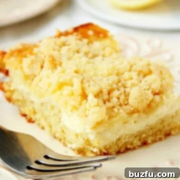 Lemon Cream Cheese Crumb Cake piece on white plate.