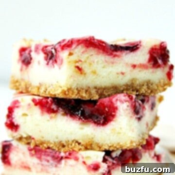 Stack of Lemon Raspberry Cheesecake Bars, showcasing their layers and deliciousness.