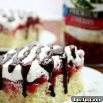 Gooey Cherry Marshmallow Bliss Poke Cake 2 Cherry Marshmallow Delight Poke Cake - vanilla cake with cherry pie filling and marshmallow whipped cream and a drizzle of fudge sauce.