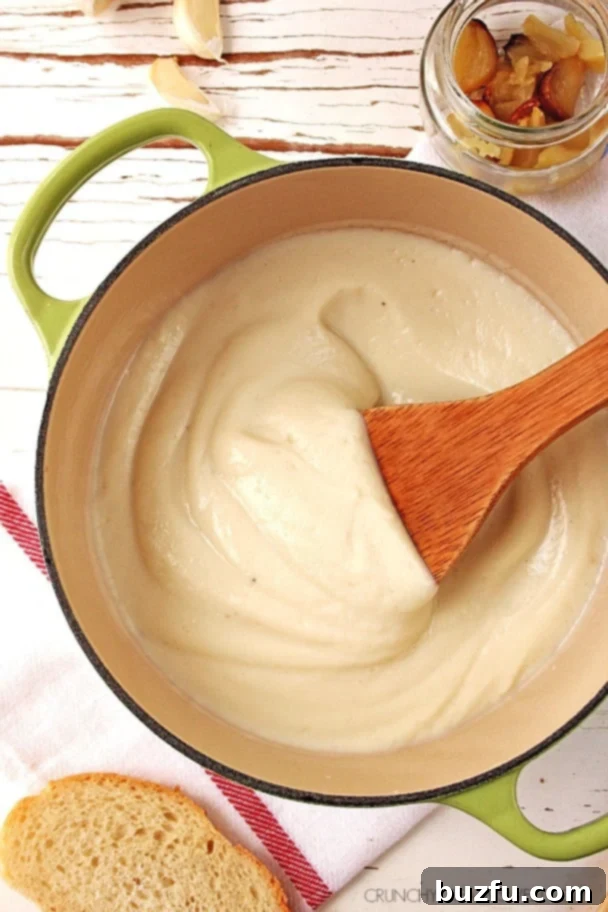 Overhead shot of creamy cauliflower Alfredo sauce in a saucepan, ready to be served.