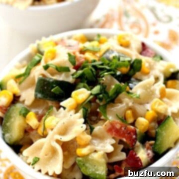 Corn and Zucchini Pasta in a white bowl.