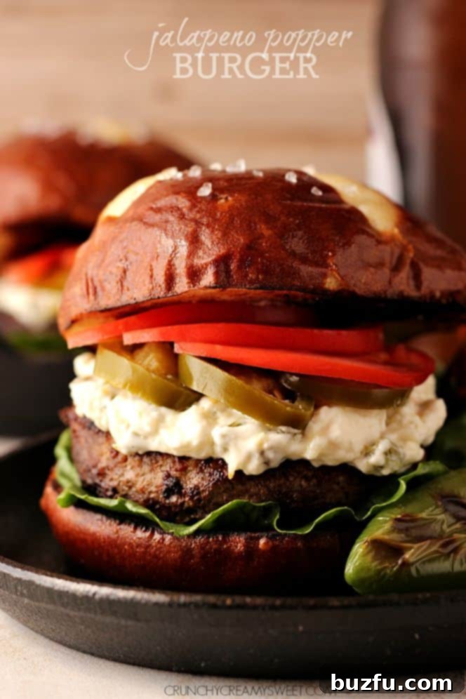 Jalapeno Popper Burger - The Ultimate Game Day Masterpiece Jalapeno Popper Burger with golden-brown pretzel bun and vibrant fresh toppings, perfect for game day