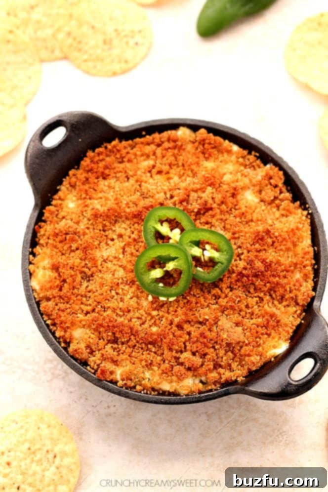 Preparing Jalapeno Popper Dip: A close look at the rich, creamy base with finely chopped pickled jalapenos and mozzarella cheese. Close-up of the creamy texture of Jalapeno Popper Dip before baking, showing the chopped jalapenos and cheese mixed in