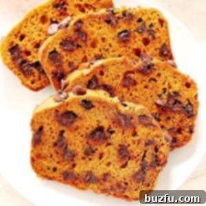 Slices of pumpkin chocolate chip bread on a white plate, ready to be served.