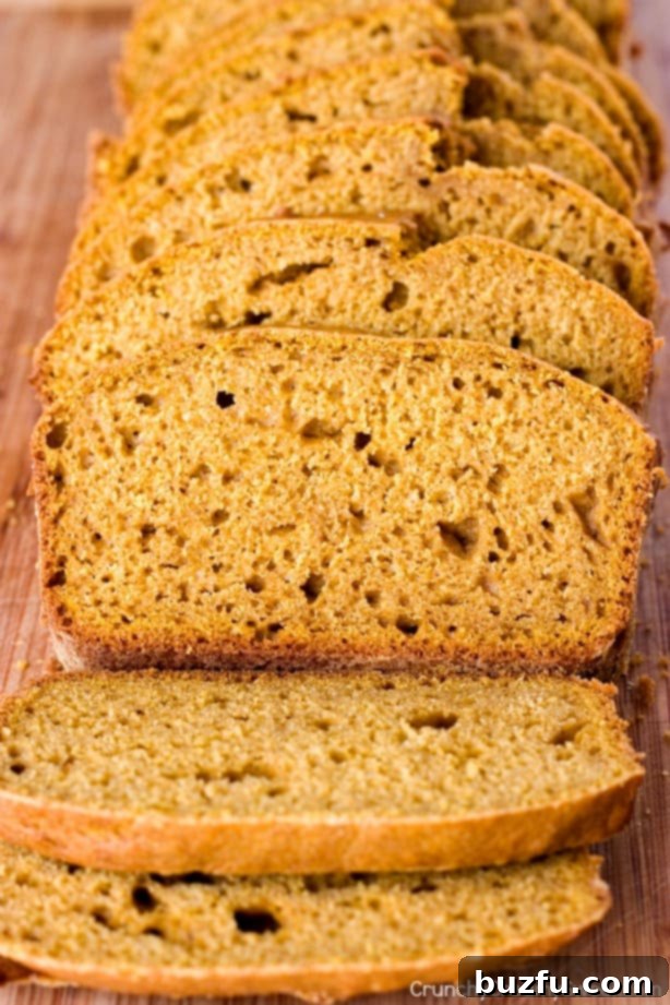 Slices of moist pumpkin bread served with a generous dollop of cinnamon cream cheese spread.
