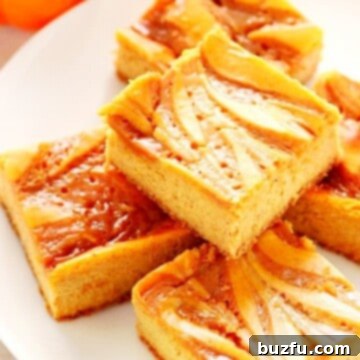 Pumpkin Cheesecake Bars on a white plate.