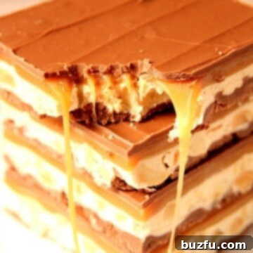 Homemade Snickers bars stacked up on each other.