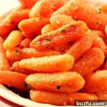 A serving of Garlic Parmesan Roasted Baby Carrots in a white bowl.