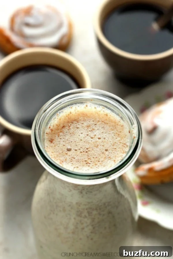 Homemade Cinnamon Roll Coffee Creamer: A Quick 5-Ingredient Recipe for Sweet Mornings Homemade Cinnamon Roll Coffee Creamer in a glass bottle next to a cup of coffee, inviting a delightful morning.