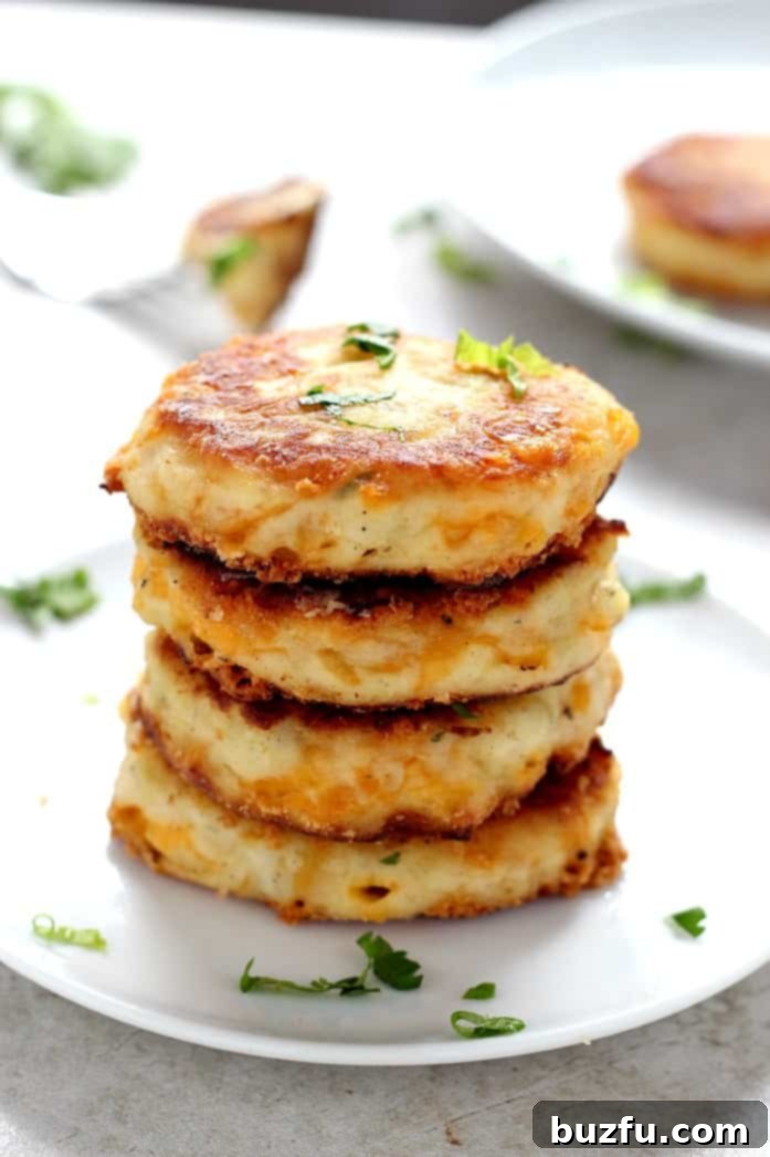 Frying Leftover Mashed Potato Cheddar Ranch Cakes in a skillet until golden brown. The process for making these crispy, cheesy patties from leftover mashed potatoes.