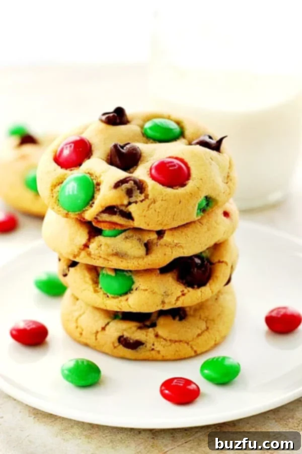 Christmas M&M Cookies - The Best Festive Treat for the Holidays! Christmas M&M Cookies stacked on white plate, showcasing their festive colors and soft texture.