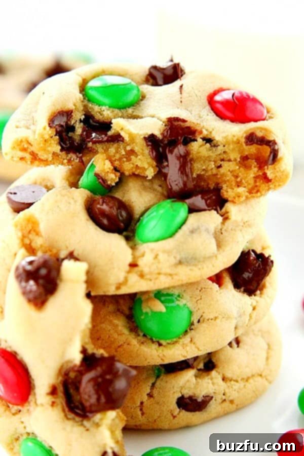 Make the best soft and chewy Christmas M&M Cookies this holiday season! Broken apart Christmas M&M Cookies, revealing gooey chocolate and a soft, chewy interior.