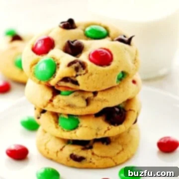 Festive M and M Delights 3 Christmas M&M Cookies stacked on a plate.