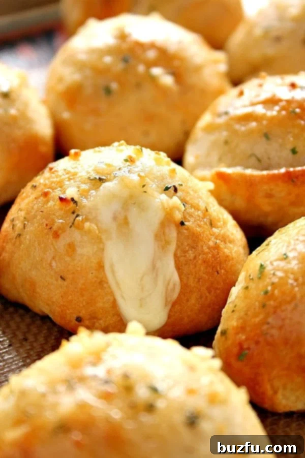 Garlic cheese bombs rolls on baking sheet. 
