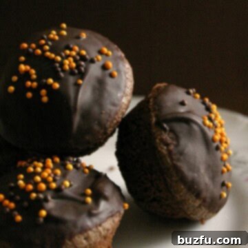 A delicious brownie bite with chocolate glaze and colorful sprinkles, perfect for a treat.