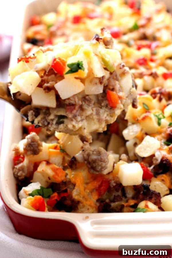 Perfect Breakfast Casserole - everything you love about breakfast in one easy and delicious casserole! Bacon, sausage, mushrooms, peppers, onions, hash browns, eggs and cheese. This breakfast bake is perfection! A perfectly baked Perfect Breakfast Casserole, golden brown and bubbling, ready to be served in a ceramic baking dish.