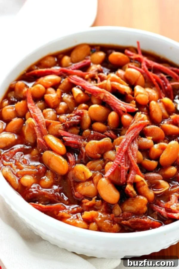 Baked beans in white bowl.