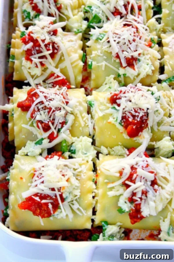 Spinach Lasagna Roll Ups - classic dish with a twist! Spinach lasagna roll ups are easy, delicious, elegant and fun to eat! A close-up shot of perfectly baked Spinach Lasagna Roll-Ups in a rectangular baking dish, bubbling with cheese and sauce.
