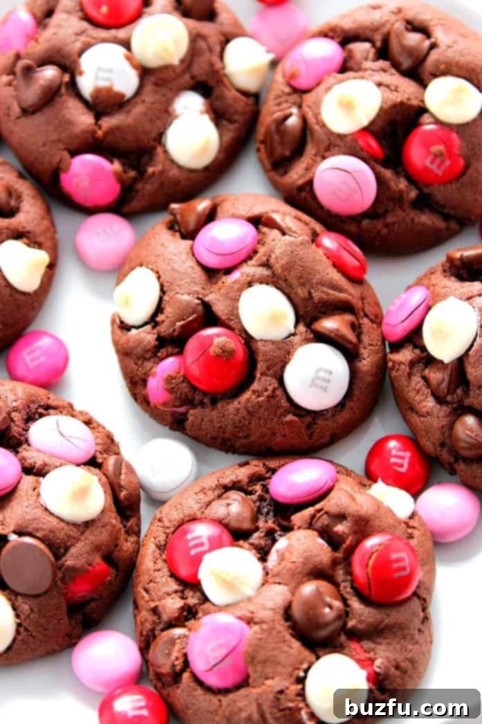Double Chocolate M&M Cookies Recipe - soft and chewy pudding cookies packed with cocoa powder, semi-sweet chocolate chips, white chocolate chips and bright red and pink M&M's! Make a batch and bake it - all in 30 minutes! 