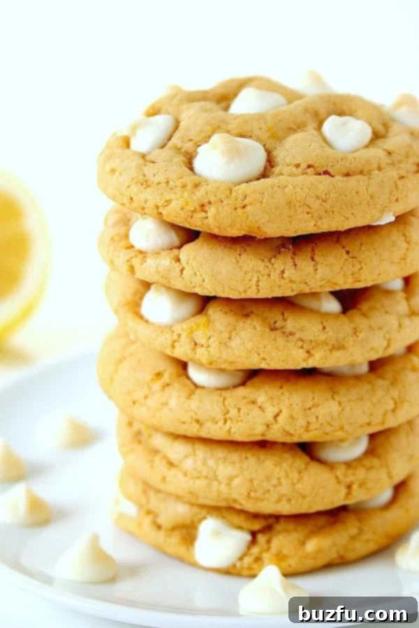 Delicious Stack of Lemon White Chocolate Chip Cookies Lemon White Chocolate Chip Cookies stacked on a plate.