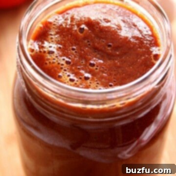 Blender Enchilada Sauce in a glass jar.