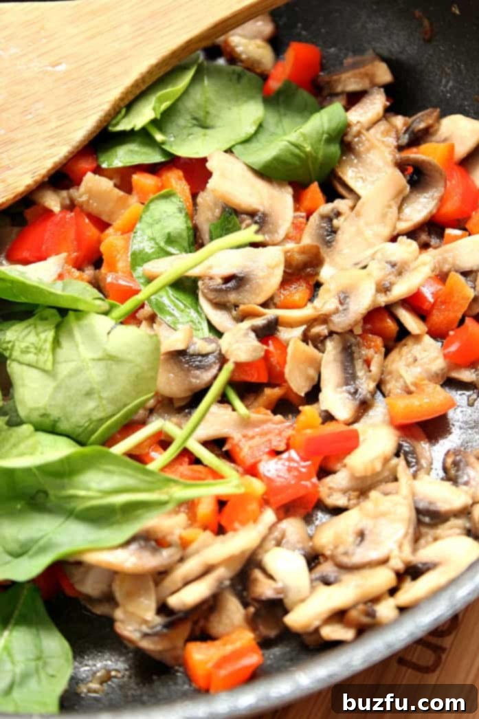 Sauteed vegetables in pan.