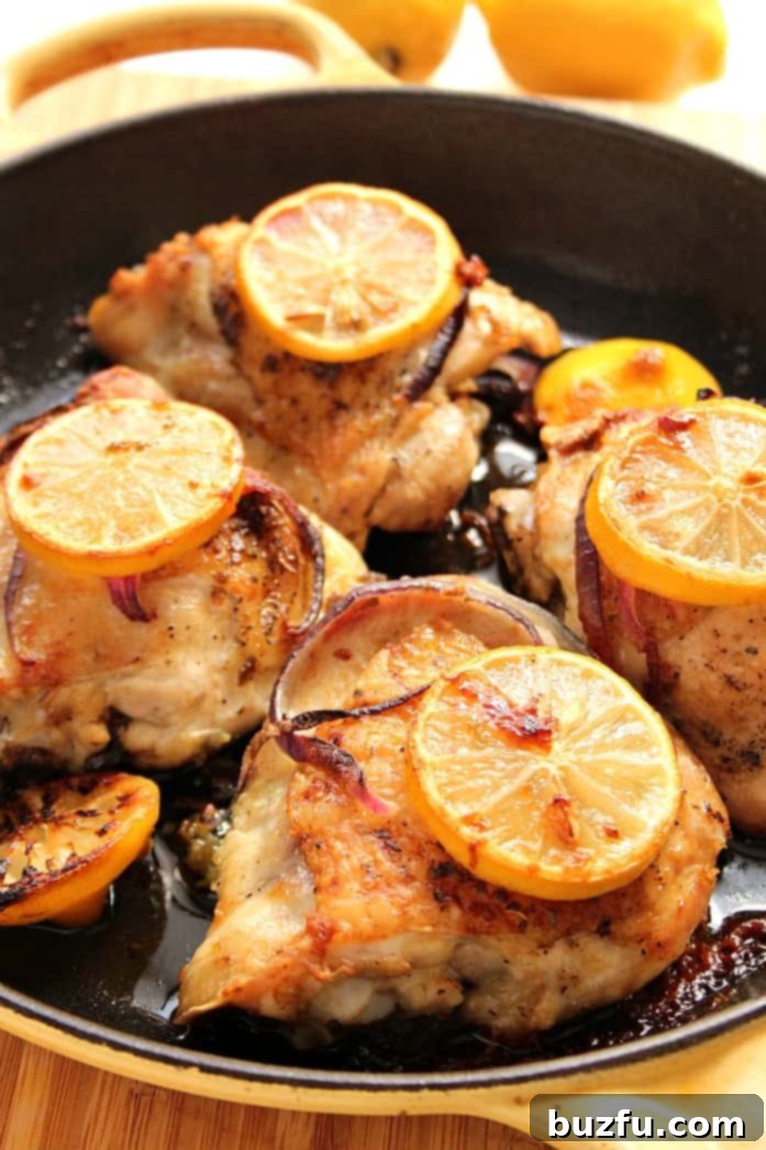 Four roasted chicken thighs in pan.