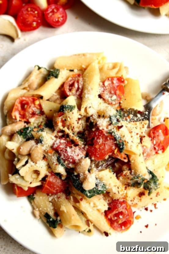 A serving of Skillet Pasta with Vegetables on a white plate, garnished with herbs.