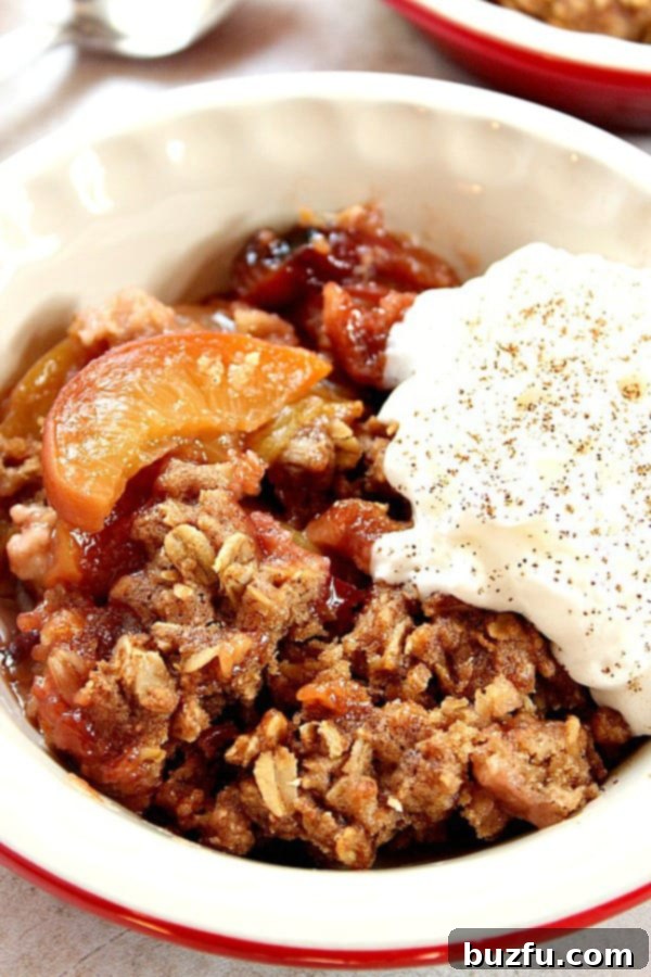 Slow Cooker Peach Crisp in a bowl with ice cream.