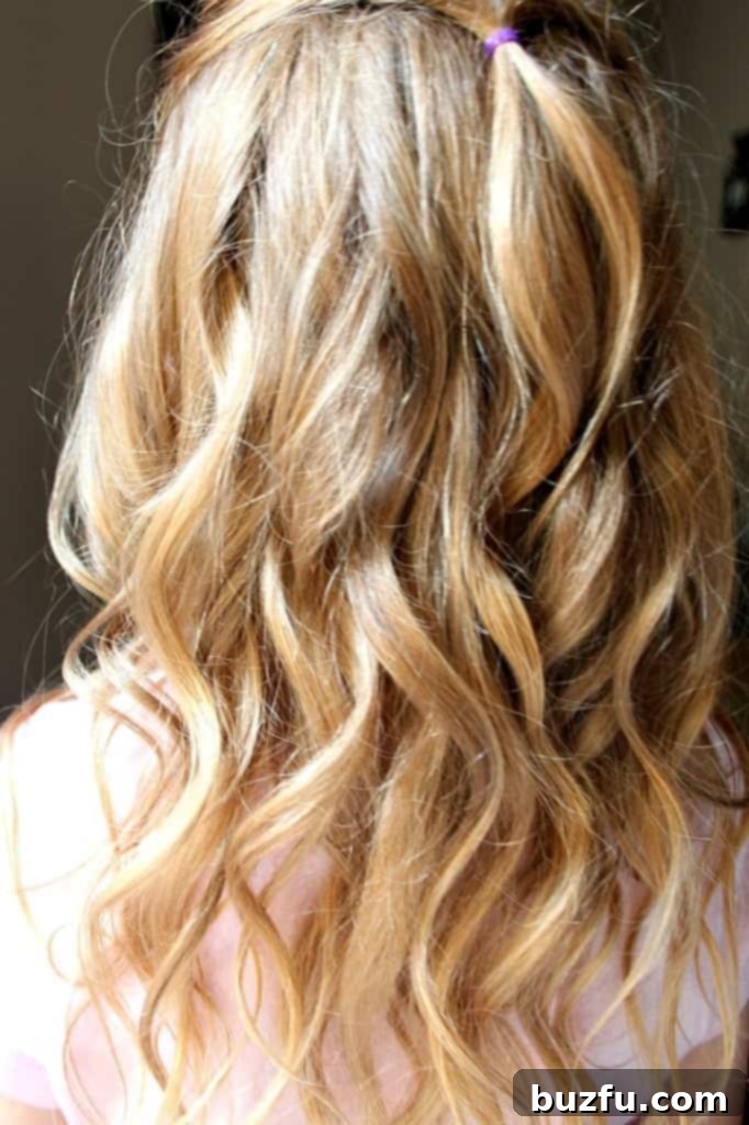 The vibrant pink NuMe Magic Wand 25mm curling tool, showcasing its sleek design and appealing color, ready for creating beautiful curls.