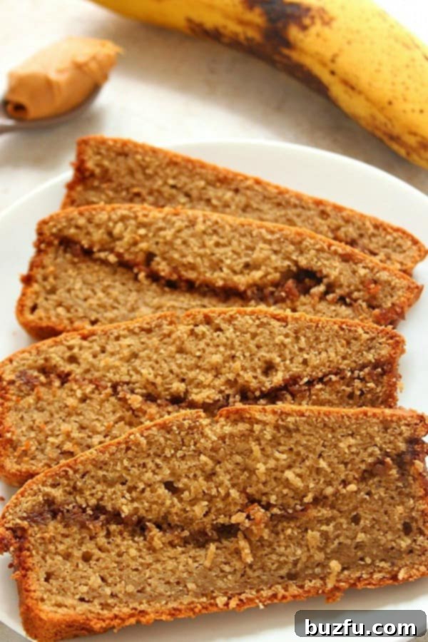 A delicious slice of Peanut Butter Banana Blender Bread on a plate, showcasing its moist texture and golden-brown crust.