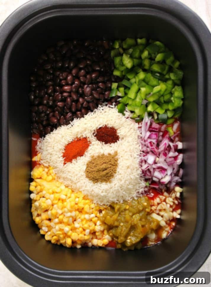 Simple Prep for Southwestern Crock-Pot Chicken and Rice Ingredients for Southwestern Crock-Pot Chicken and Rice being stirred in a slow cooker before cooking.