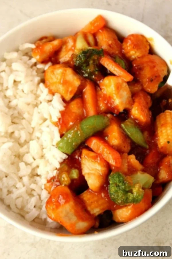 Effortless Honey Chipotle Chicken Rice Bowls 2 A vibrant bowl of honey chipotle chicken, rice, and colorful vegetables, garnished with fresh cilantro.