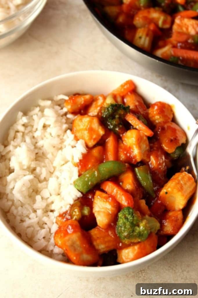 Effortless Honey Chipotle Chicken Rice Bowls 4 A top-down view of a completed honey chipotle chicken rice bowl, showcasing the generous portion of chicken, rice, and mixed vegetables.
