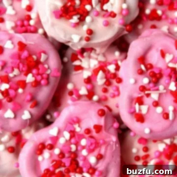 Chocolate Pretzel Hearts Recipe Pile of Pink Chocolate Pretzel Hearts, garnished with funfetti.