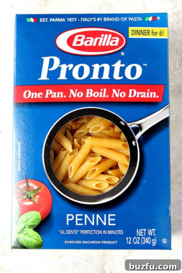 Barilla Pronto pasta package next to a bowl of prepared pasta dish.