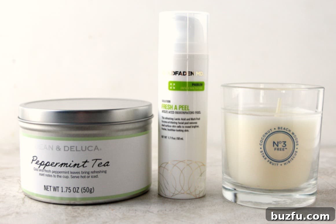 Contents of the POPSUGAR Must Have Box, including a facial peel, candle, and tea.