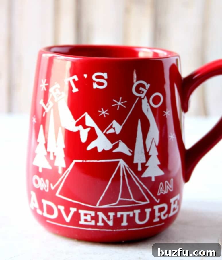 Two 'honey pot' shaped mugs with travel-themed designs.