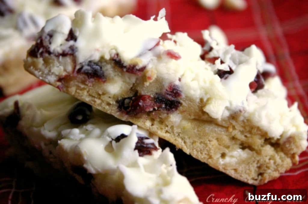 A tray of Cranberry Bliss Bars with coconut, ready to be cut into triangles