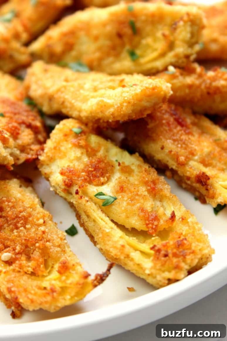 A beautifully presented serving of Baked Artichoke Hearts on a plate, ready to be enjoyed.