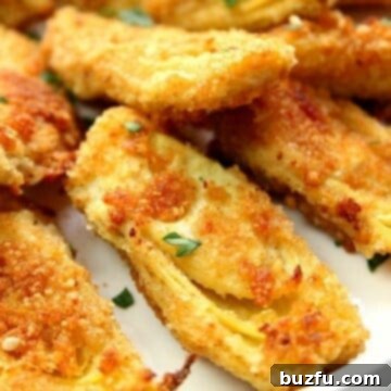 Baked Artichoke Hearts on white plate.