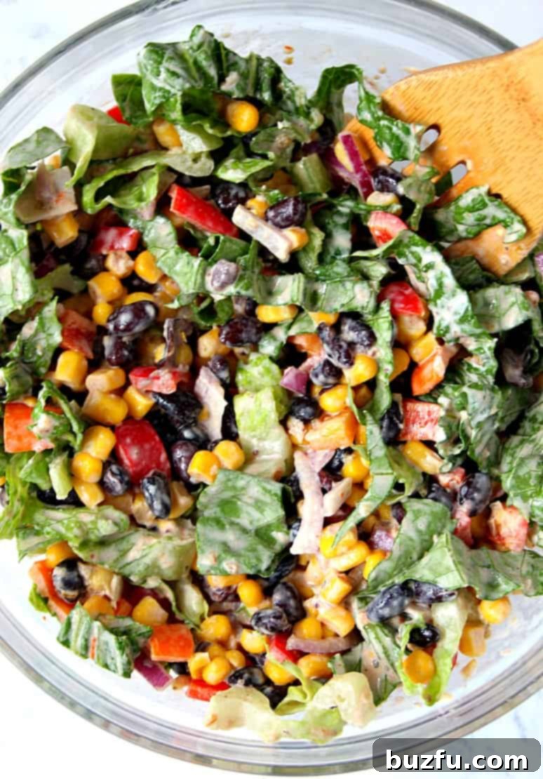 Fresh ingredients for Black Bean Taco Salad, including black beans, corn, peppers, and lettuce.