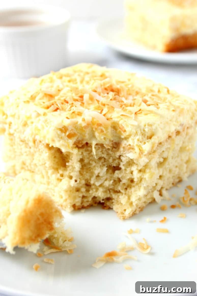 Delicious Coconut Pineapple Cake Recipe A vibrant close-up of the complete Coconut Pineapple Cake, showcasing its golden-brown top and luscious pineapple frosting, ready to be served as a perfect Summer dessert.